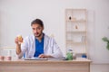 Young male odontologist working in the clinic