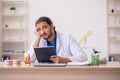 Young male odontologist working in the clinic