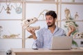 Young male paleontologist examining ancient animals at lab Royalty Free Stock Photo