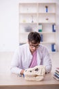 Young male paleontologist examining ancient animals at lab Royalty Free Stock Photo