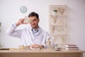 Young male paleontologist examining ancient animals at lab Royalty Free Stock Photo