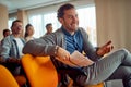 Young male participant is having a pleasant conversation with a lecturer during a business lecture in the conference room. Royalty Free Stock Photo