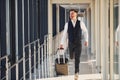 Young male passenger in elegant formal clothes is in the airport hall Royalty Free Stock Photo