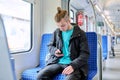 Young male passenger sitting inside an electric intercity train