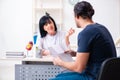 Young male patient visiting aged female doctor Royalty Free Stock Photo