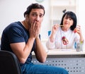 Young male patient visiting aged female doctor Royalty Free Stock Photo