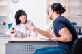 The young male patient visiting aged female doctor Royalty Free Stock Photo