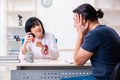 Young male patient visiting aged female doctor Royalty Free Stock Photo