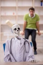 Young male patient visiting skeleton doctor
