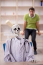 Young male patient visiting skeleton doctor Royalty Free Stock Photo