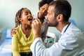 Young male pediatrician doctor examining child at office. Healthcare prevention exam people concept Royalty Free Stock Photo