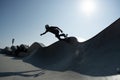 Young male performing skateboarding at an outdoor skateboard park