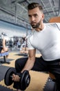 Young male performing TRX training at the gym