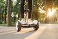 Young male person riding on gyroboard in park