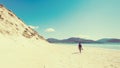 Young male photographer with dreadlocks at a sunny white sand beach Royalty Free Stock Photo