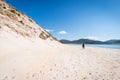 Young male photographer with dreadlocks at a sunny white sand beach Royalty Free Stock Photo