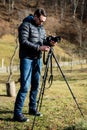 Young male photographer preparing the camera