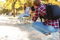 Young male photographer taking photo of model with professional camera Royalty Free Stock Photo