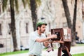 Young male photographer taking pictures using a vintage wooden camera