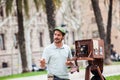 Young male photographer taking pictures using a vintage wooden camera