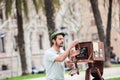 Young male photographer taking pictures using a vintage wooden camera