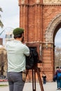 Young male photographer taking pictures using a vintage wooden camera