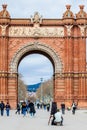 Young male photographer taking pictures using a vintage wooden cameraTriumphal Arch in Barcelona Spain