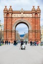 Young male photographer taking pictures using a vintage wooden cameraTriumphal Arch in Barcelona Spain