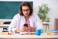 Young male physicist in the classroom