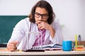 Young male physicist in the classroom