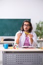 Young male physicist in the classroom