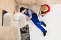 Young Male Plumber Fixing Sink In Bathroom Royalty Free Stock Photo