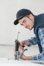 Young male plumber hand fixing tap sink in bathroom