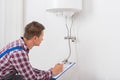 Male Plumber Checking Electric Boiler Royalty Free Stock Photo