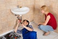 Young Male Plumber Repairing Sink In Bathroom Royalty Free Stock Photo