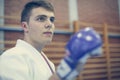 Young male practicing judo in kimono with fight glove. Royalty Free Stock Photo