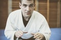 Young male practicing judo in kimono. Royalty Free Stock Photo