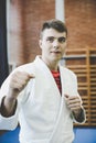 Young male practicing judo in kimono. Royalty Free Stock Photo