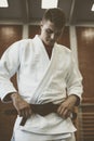 Young male practicing judo in kimono. Royalty Free Stock Photo