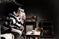 Young male prisoner sitting on a bed and licking aluminum plate Royalty Free Stock Photo