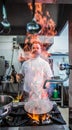 Chef preparing beef fillet steak in a frying pan with exploding flame