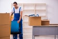 Young male professional mover doing home relocation