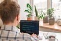 A young male programmer uses a laptop and types code in the office. Software, programming concept Royalty Free Stock Photo