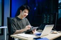 Young male programmer working with tablet and screen displaying code. Modern tech office setup, great for software, coding, IT Royalty Free Stock Photo