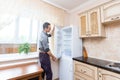Young Male Repairman Fixing Refrigerator In Kitchen Royalty Free Stock Photo