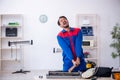 Young male repairman repairing air-conditioner Royalty Free Stock Photo