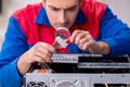 Young male repairman repairing computer Royalty Free Stock Photo