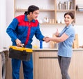 Young male repairman repairing washing machine Royalty Free Stock Photo