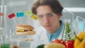 Young male researcher examines a sample of burger labeled E142, E240, E121 and E160. Biolog analyzes the quality of the