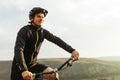 Young male riding bicycle among mountains Royalty Free Stock Photo